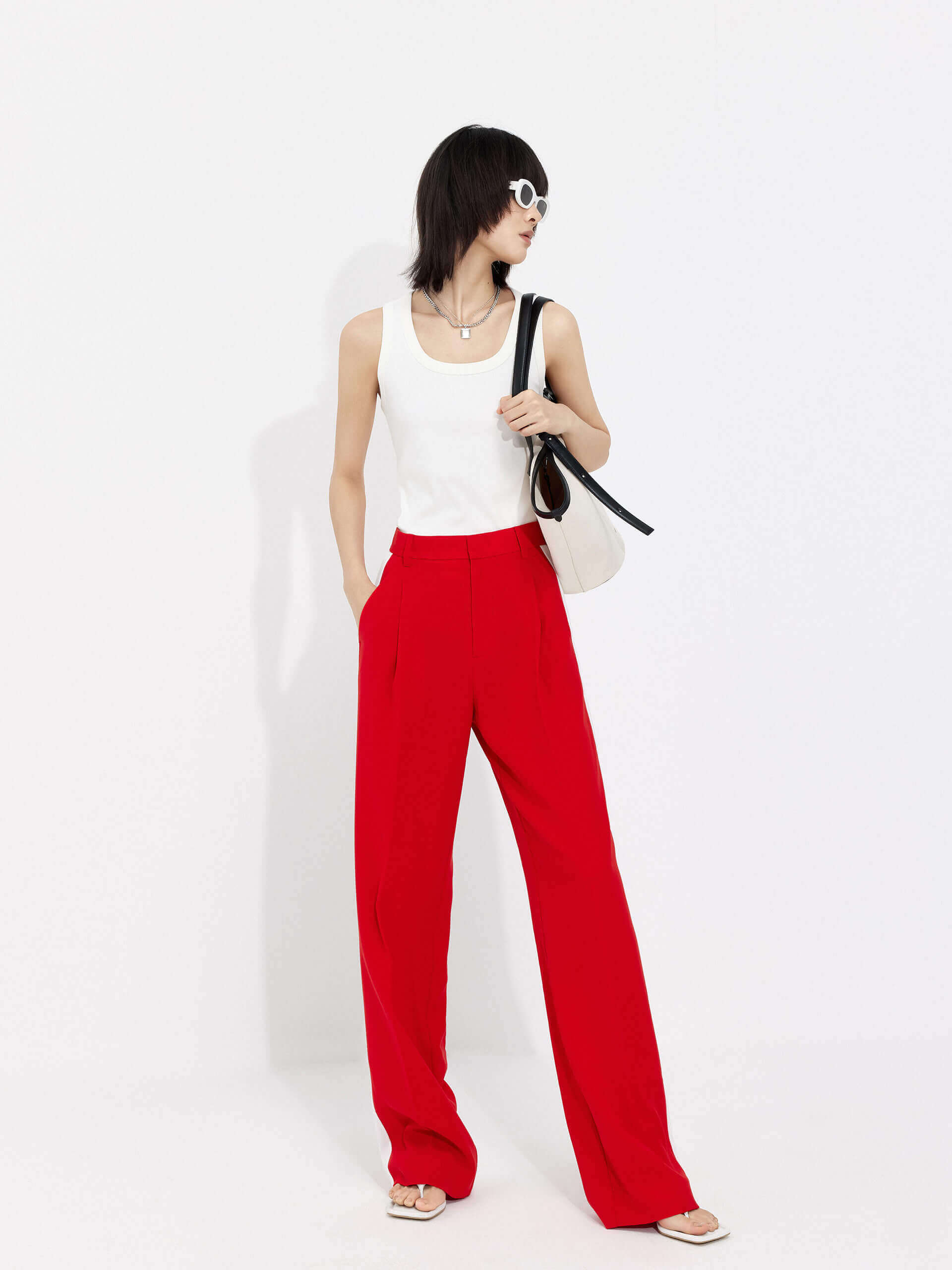 MO&Co. Women's Contrast Trim Suit Pants in Red offer timeless style and lasting comfort. Features include contrast trim design, straight leg, side pockets, belt loops, and a zipper and hook closure.