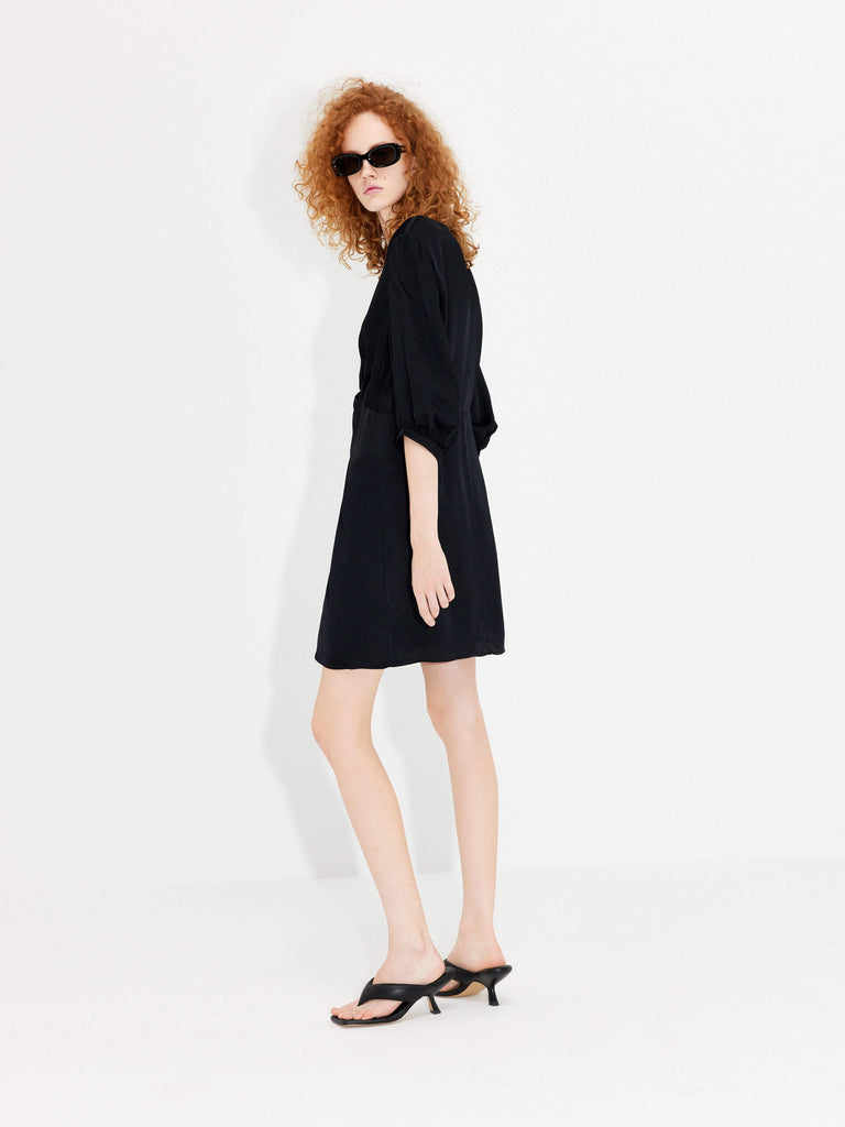 MO&Co. Women's Twisted Front V-neck Mini Dress in Black crafted with eco-friendly regenerated fibers.
