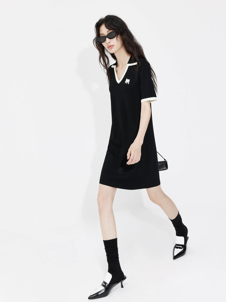 MO&Co. Women's Polo Collar Contrast Black Dress features include a V-neck with collar design, contrasting trim details, and an embroidered M logo patch front. 