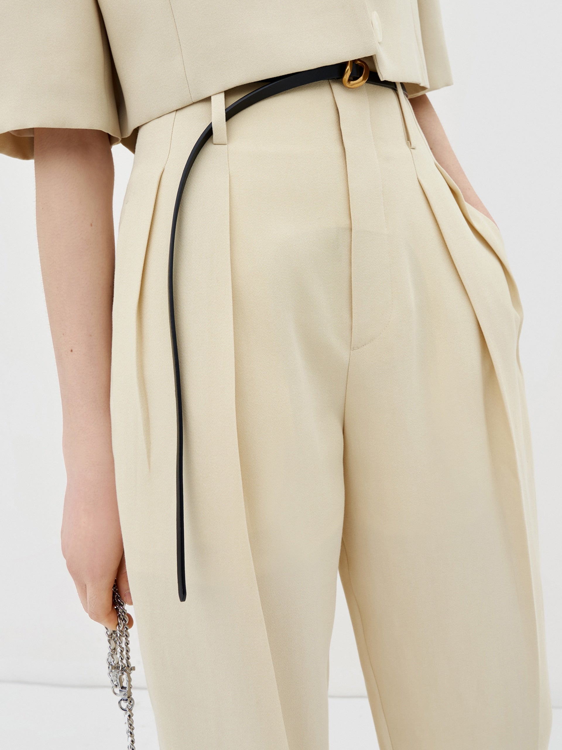 MO&Co. Women's Pleated Suit Pants with Belt in Camel features high-rise, slit detail at hems, straight leg fit.