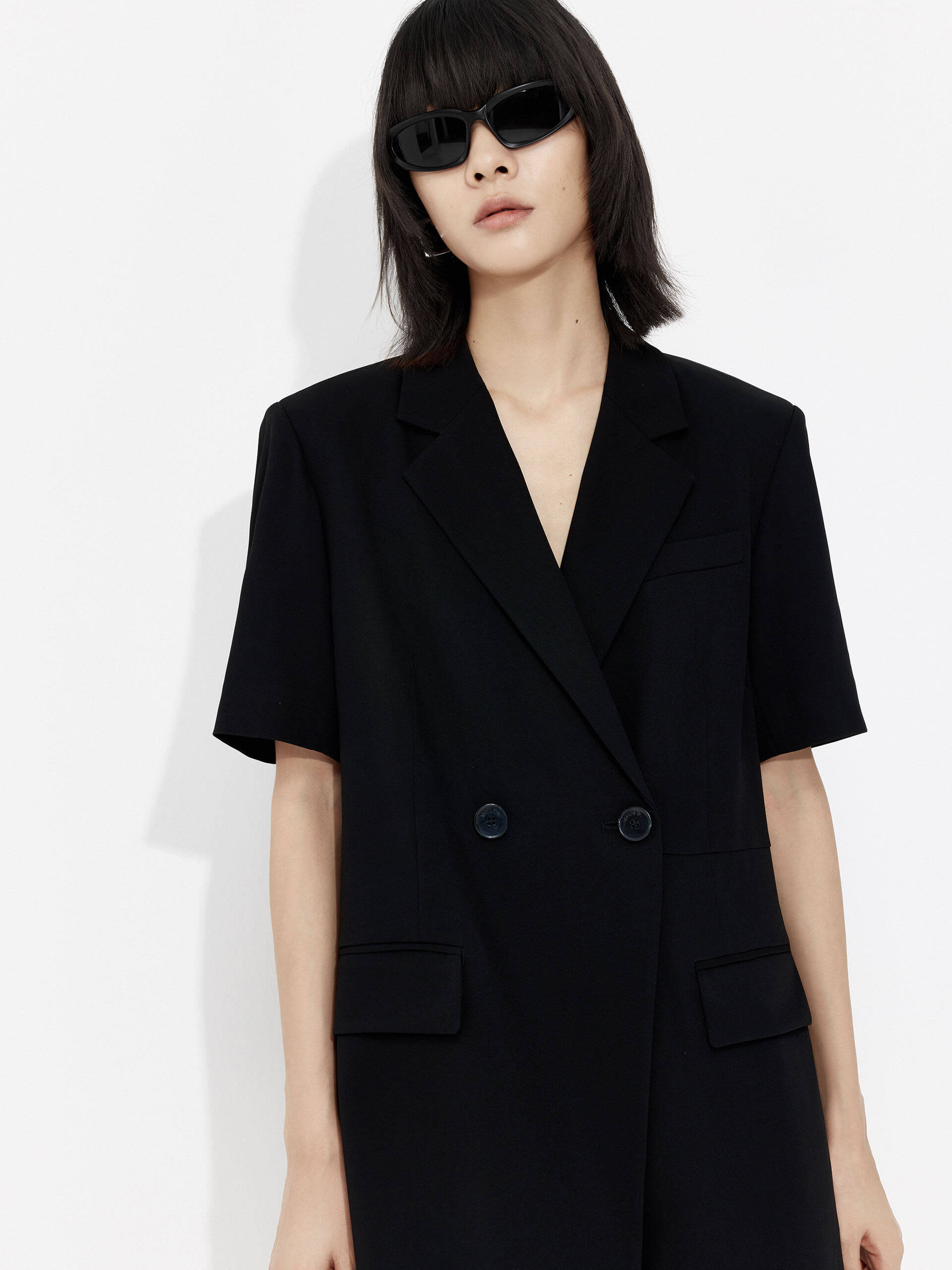 MO&Co. Women's V Neck Acetate Blend Blazer Romper in Black. Its double-breasted design provides a timeless silhouette, while its relaxed fit and V-neck complements your figure.