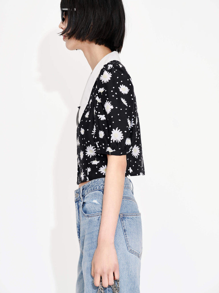 MO&Co.'s Floral Print Crop Top in Black offers a luxuriously stylish addition to any summer wardrobe. Made from a silk blend, this top features a Chelsea neckline, bubble sleeves and a beautiful floral and polka dot print design.
