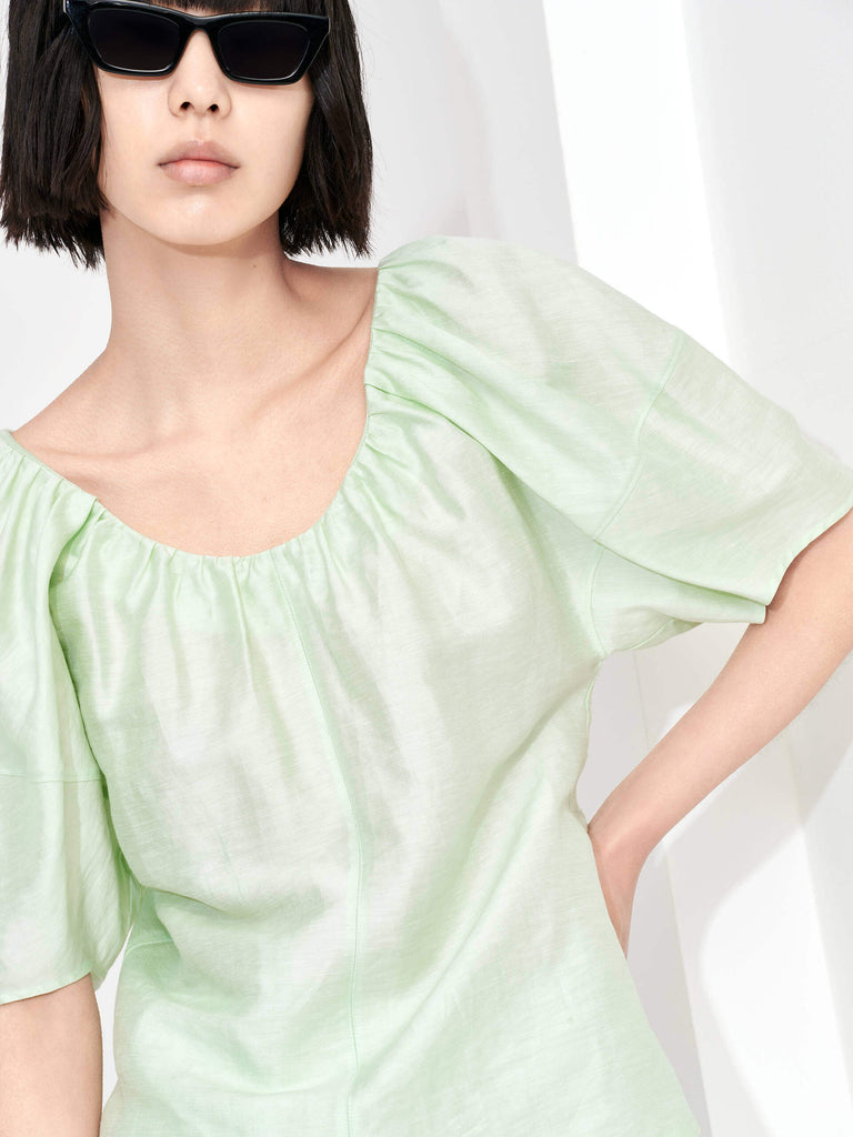 Stay cool and stylish in the MO&Co. Women's Linen Blend Relaxed Top in Mint. This lightweight top features a gathered neckline, soft glossy linen blend material, and a loose fit for ultimate comfort in the summer heat. The perfect choice for effortless summer style.