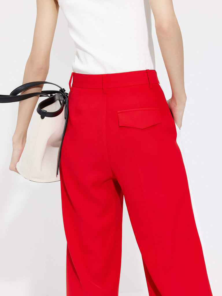 MO&Co. Women's Contrast Trim Suit Pants in Red offer timeless style and lasting comfort. Features include contrast trim design, straight leg, side pockets, belt loops, and a zipper and hook closure.