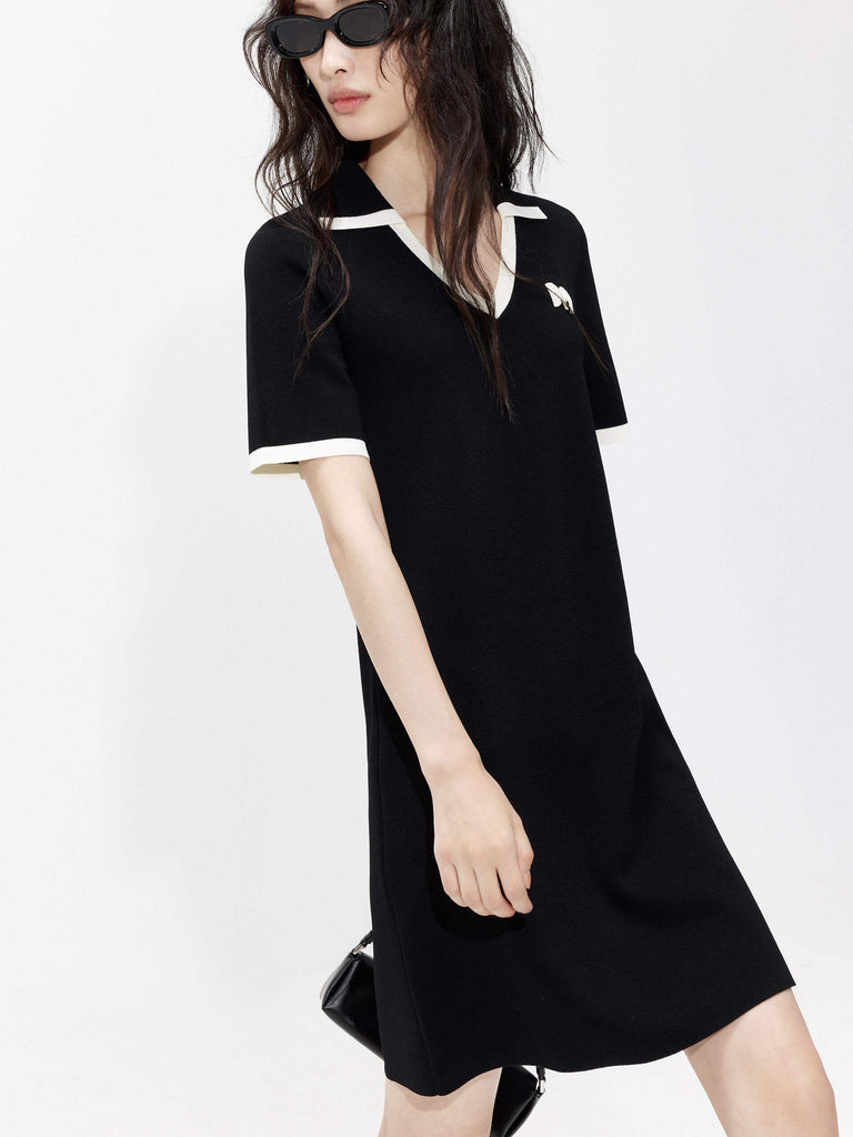 MO&Co. Women's Polo Collar Contrast Black Dress features include a V-neck with collar design, contrasting trim details, and an embroidered M logo patch front. 