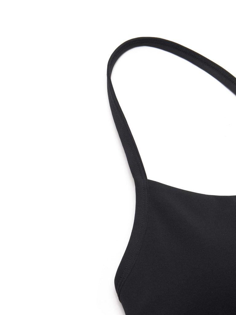 MO&Co. Women's Cropped Sports Bra in Black offers versatile style ideal for any activity. Its scoop neck, racerback, and elasticized hem provide ultimate comfort. Plus, it features UPF 40+ sun protection. Crafted with cool touch fabric and equipped with non-adjustable thin straps and removable cups.